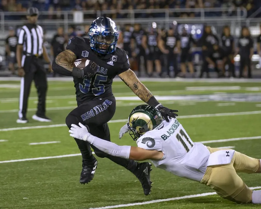 Le running back Toa Taua (35) du Nevada s'éloigne du defensive back Henry Blackburn (11) du Colorado State pendant la première mi-temps d'un match de football universitaire NCAA à Reno, Nev, Vendredi 7 octobre 2022.
