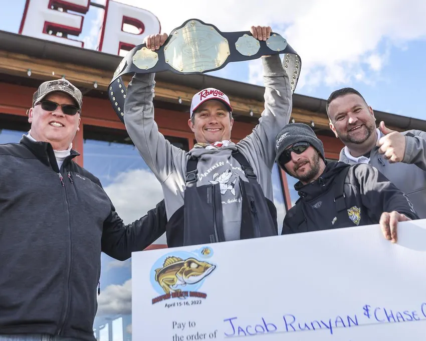 De gauche à droite, le maire de Rossford, Ohio, Neil MacKinnon III, les champions du tournoi Rossford Walleye Roundup, Jacob Runyan, Chase Cominsky, et le directeur général de Bass Pro Shops, Tony Williamson, célèbrent le samedi 16 avril 2022 chez Bass Pro Shops à Rossford. Les procureurs de Cleveland enquêtent sur un scandale apparent de tricherie lors du lucratif tournoi de pêche au doré jaune sur le lac Érié. Une vidéo publiée sur Twitter montre Jason Fischer, directeur du tournoi de pêche au doré jaune du lac Érié, en train de découper un doré jaune et de découvrir des poids en plomb et des filets de poisson préparés à l'intérieur de la prise gagnante de cinq poissons afin de renforcer leur poids. Les pêcheurs Runyan et Cominsky ont été disqualifiés.